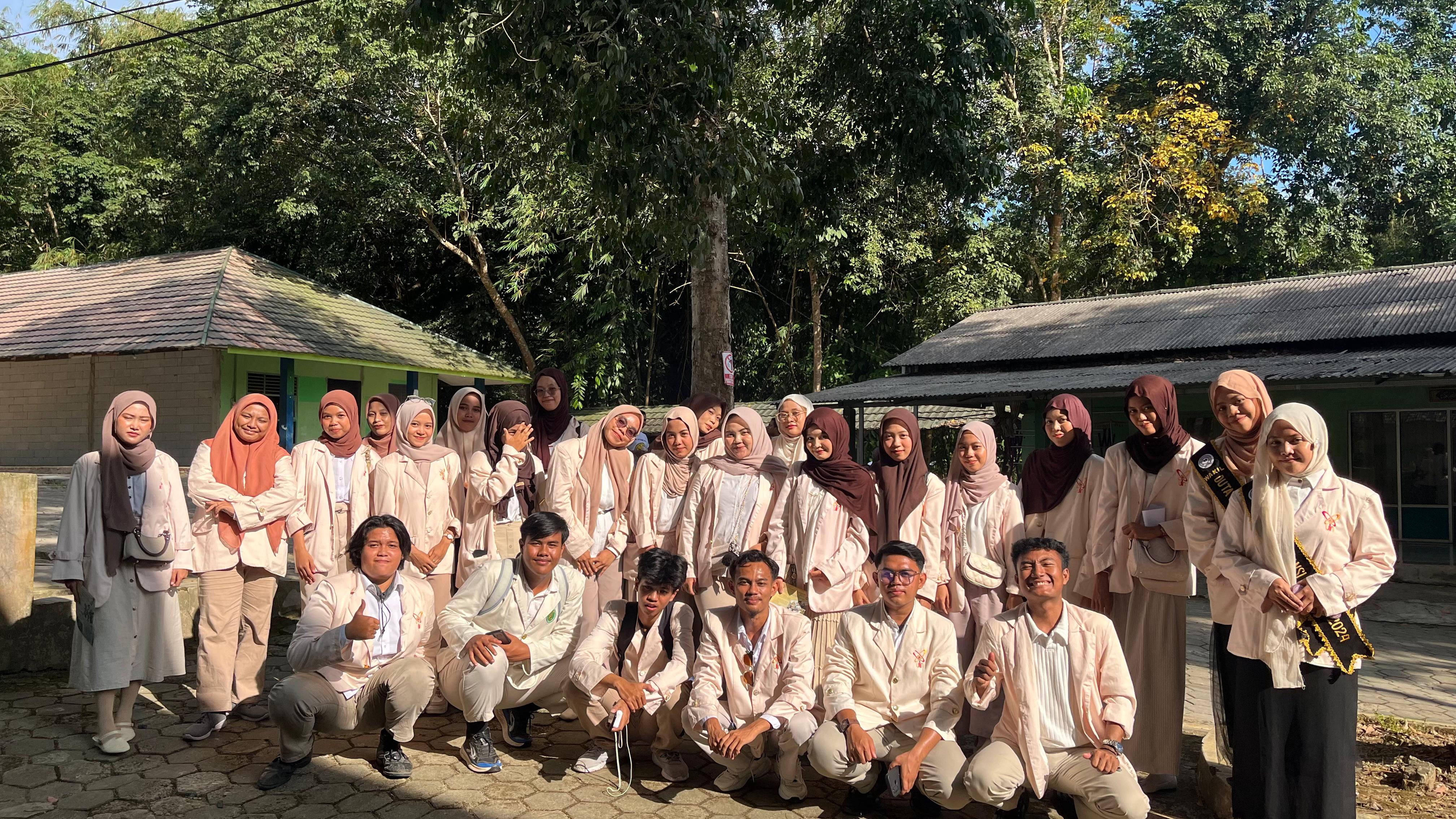 Group of students posing outdoors wearing white clothes